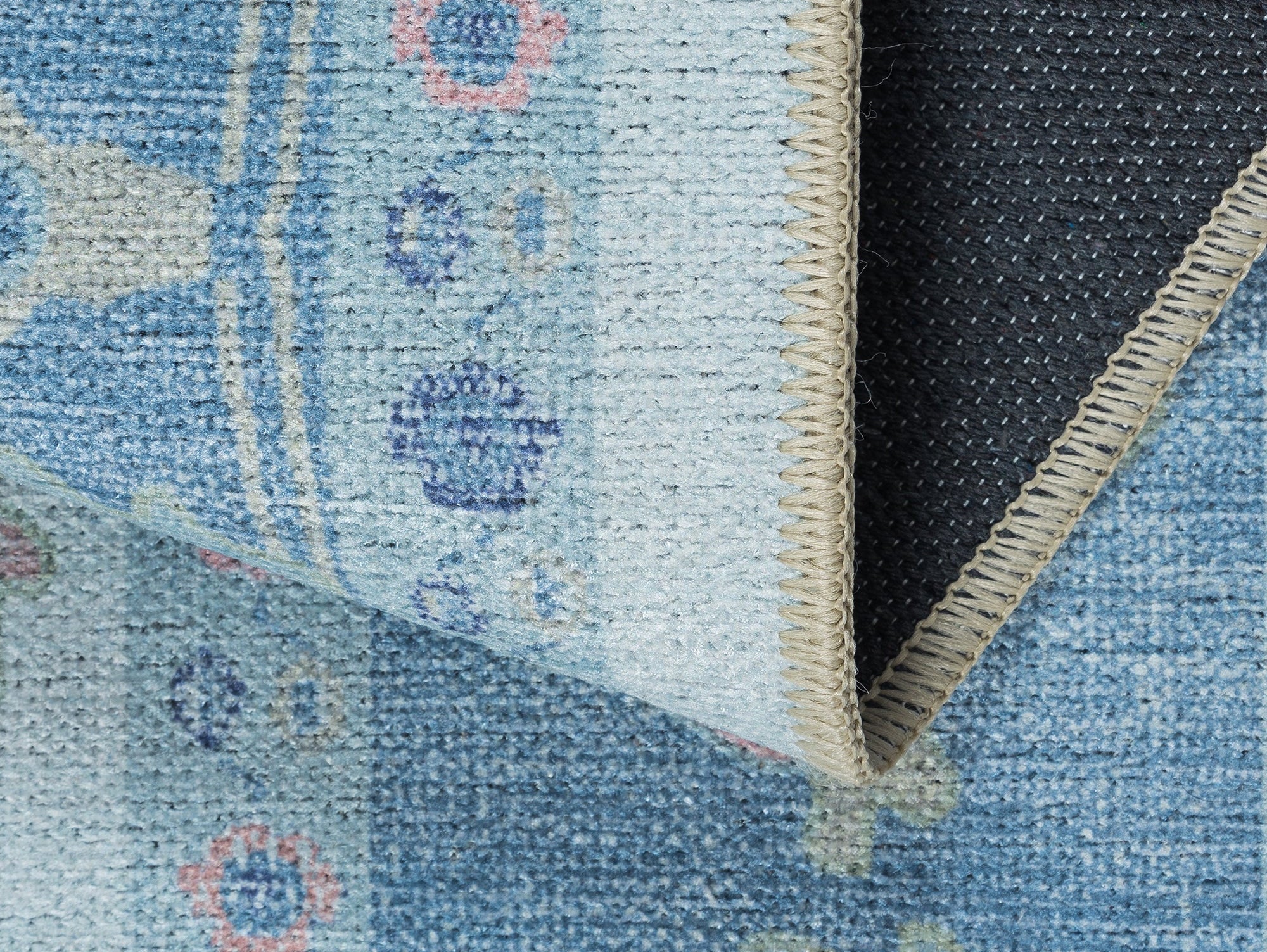 Close-up of a flatweave rug, showcasing its thin profile and clean, woven texture, for a modern minimalist style.
