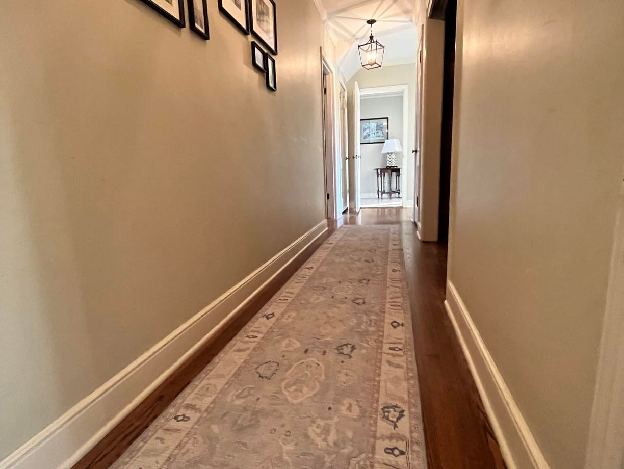 Washable gray Oushak runner rug enhancing a bright hallway with vintage-inspired charm