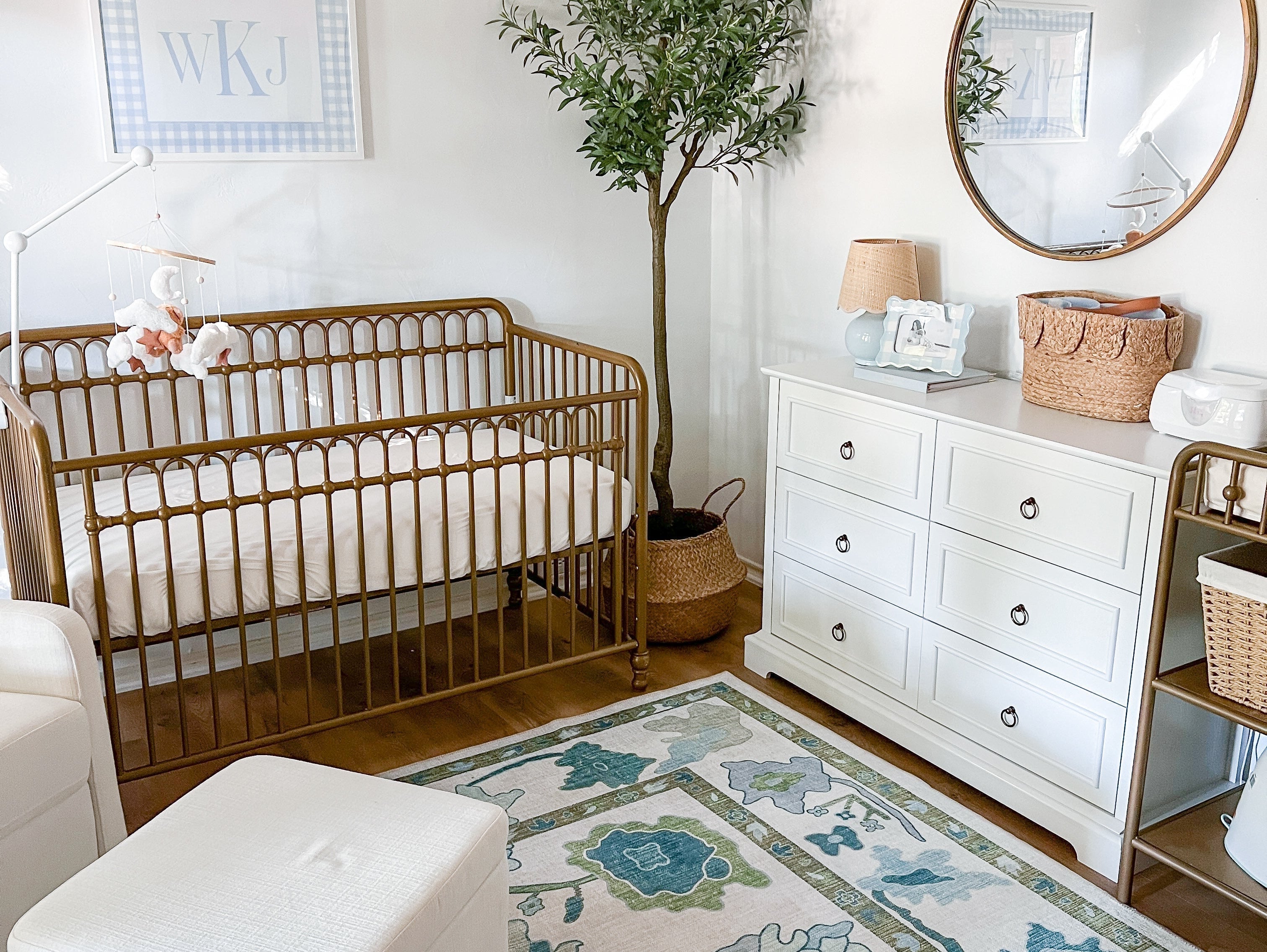 Floral green and blue Oushak-style rug creating a cozy and calming nursery space