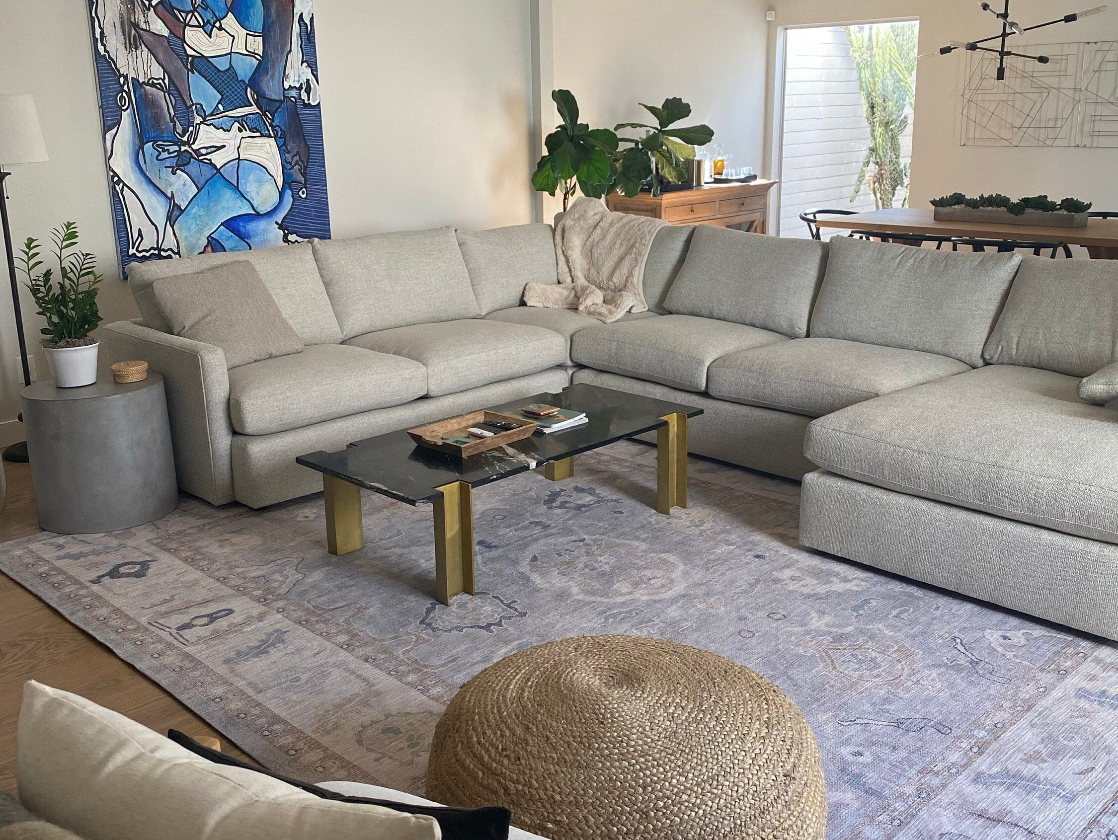 Modern living room styled with a gray Oushak rug, showcasing one of the trending rug styles for 2026 with a calm, contemporary interior design