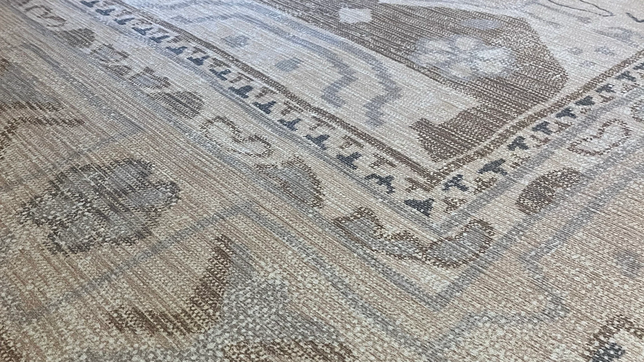 Neutral beige area rug in a modern interior creating a calm, bright, and airy spring space