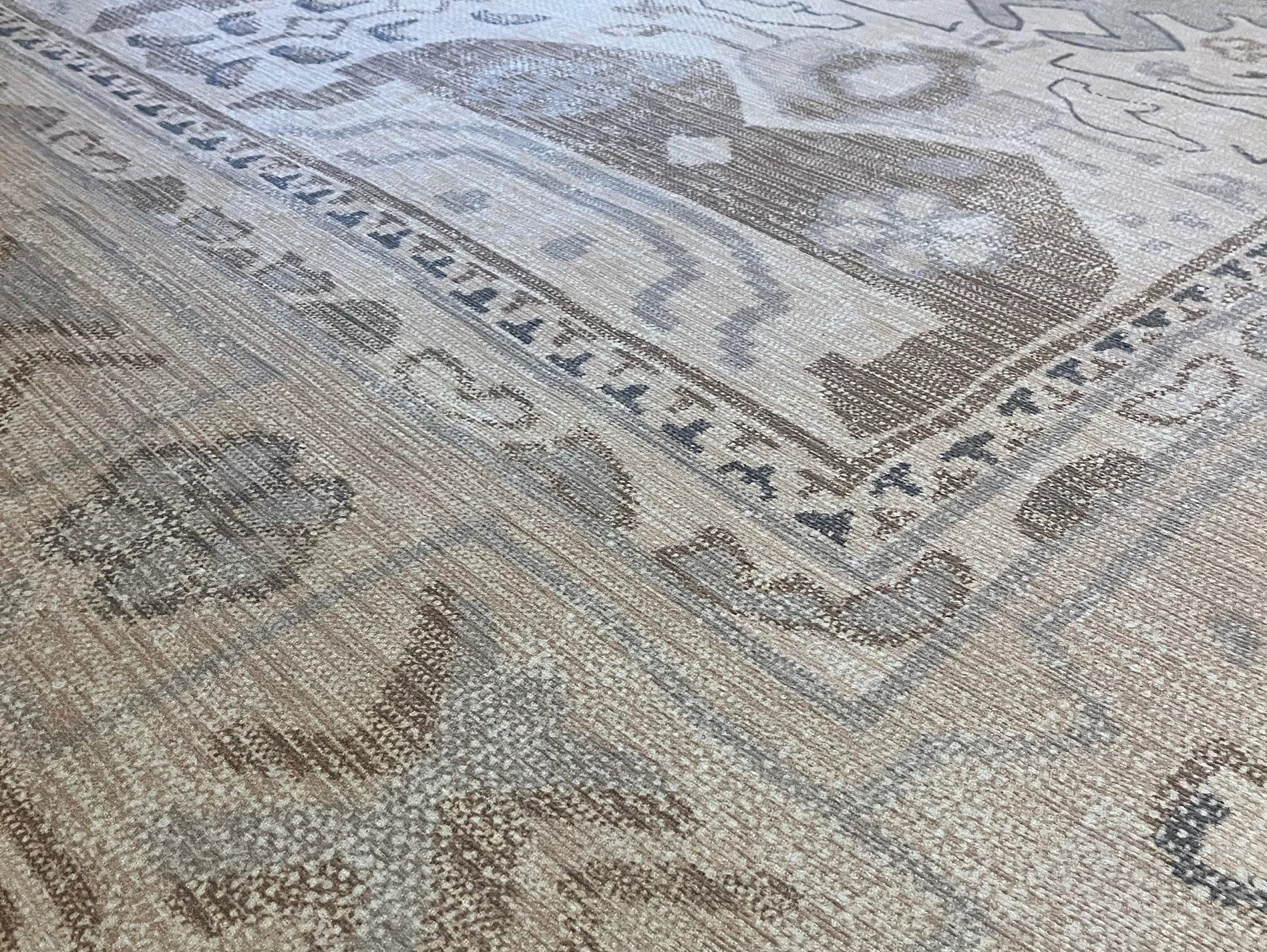 Neutral beige area rug in a modern interior creating a calm, bright, and airy spring space