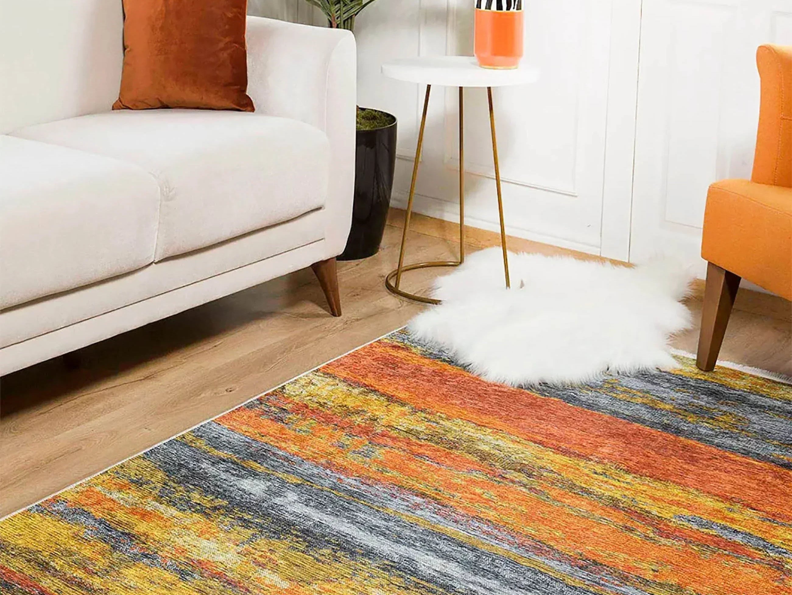 Ochre area rug adding warmth and color to a minimalist living room with beige furniture.