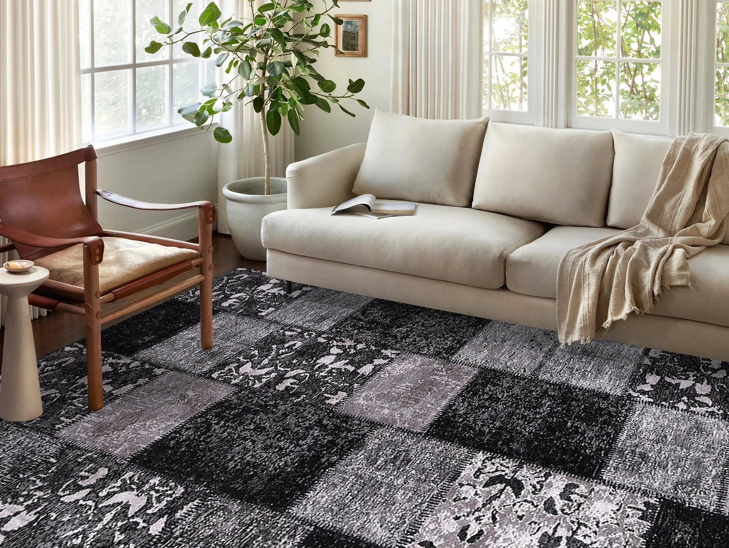 A modern living room styled with a black and white rug, featuring minimalist furniture and monochrome dΓ©cor elements.