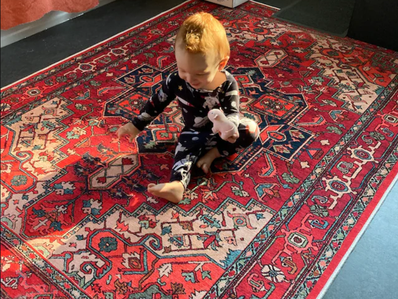 Kid-Friendly Turkish bold red rug giving a warm vibe to the playroom.