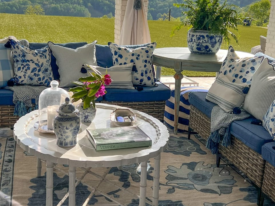 Sunny outdoor seating area featuring a light-colored summer rug, creating a fresh and inviting vibe perfect for warm-weather lounging