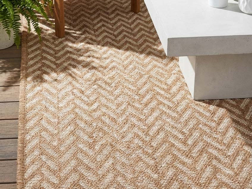 Neutral area rug in an outdoor patio creating a calm, modern, and stylish living space