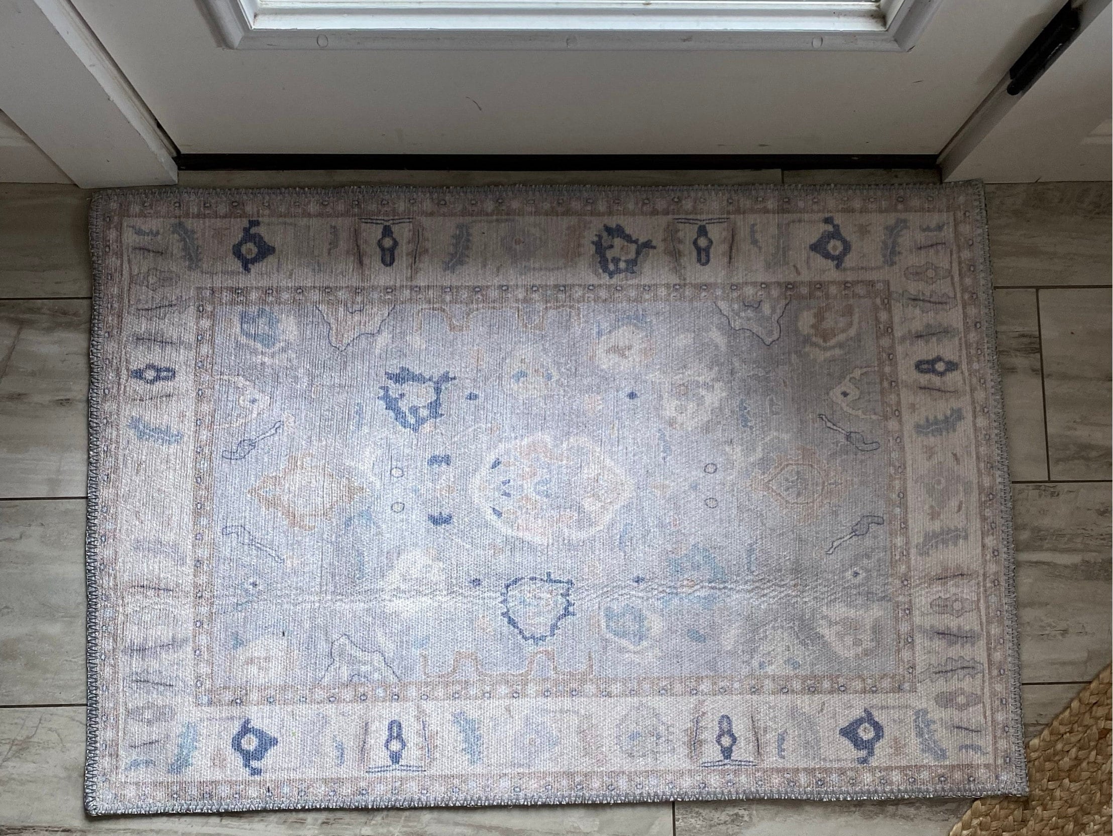 Welcoming entryway with a 2x3 rug placed near the door, adding warmth, style, and a functional touch to the small space.