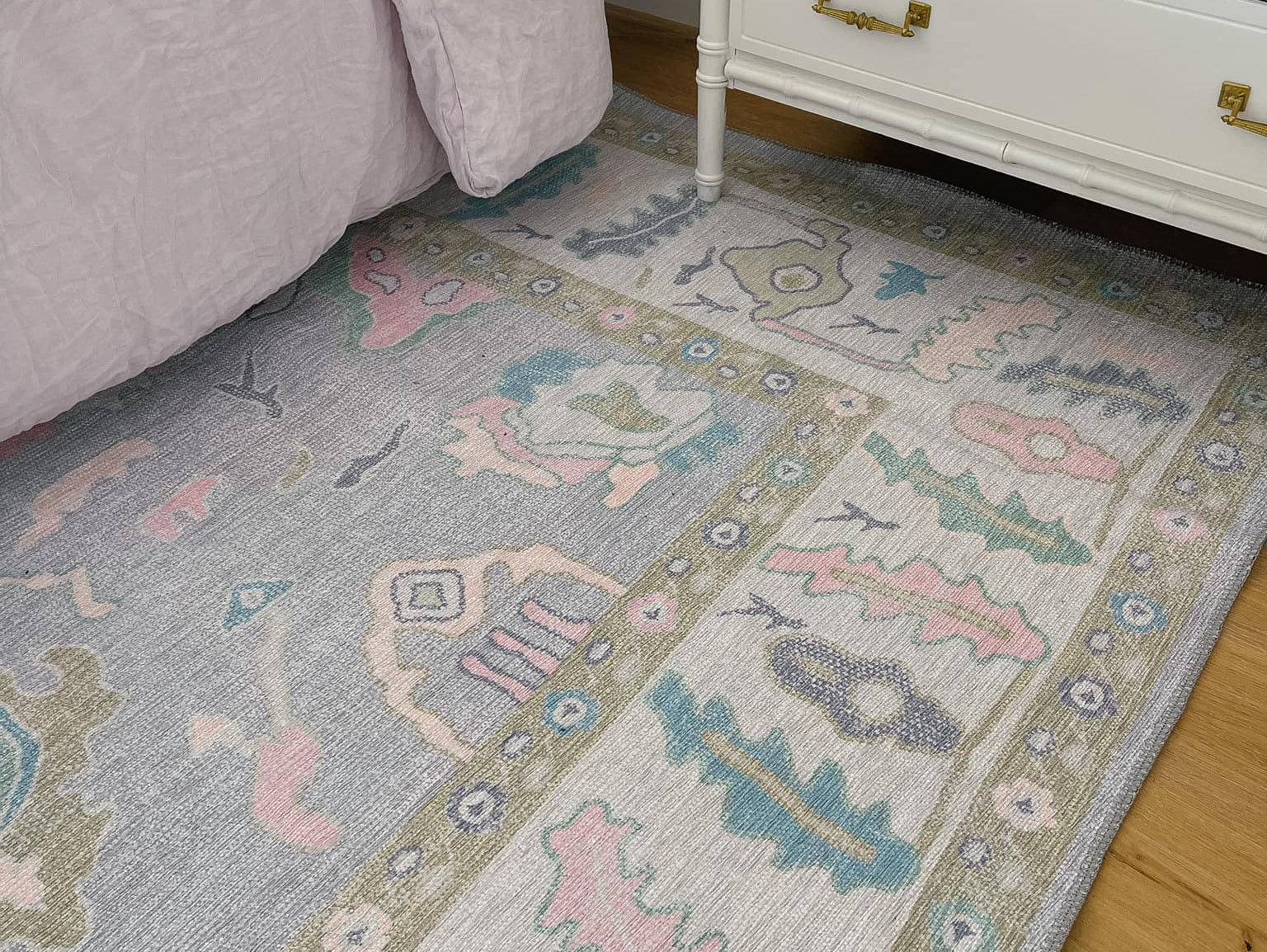 Stylish dorm room rug with a soft, low-pile texture in neutral tones, placed under a bed and desk to add warmth and define the space.
