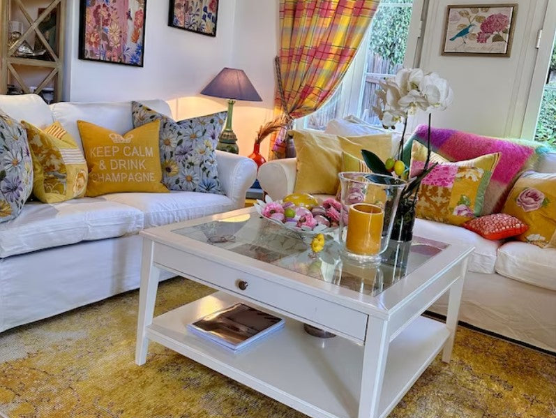 Yellow area rug anchoring a well-designed room and bringing warmth, balance, and visual focus