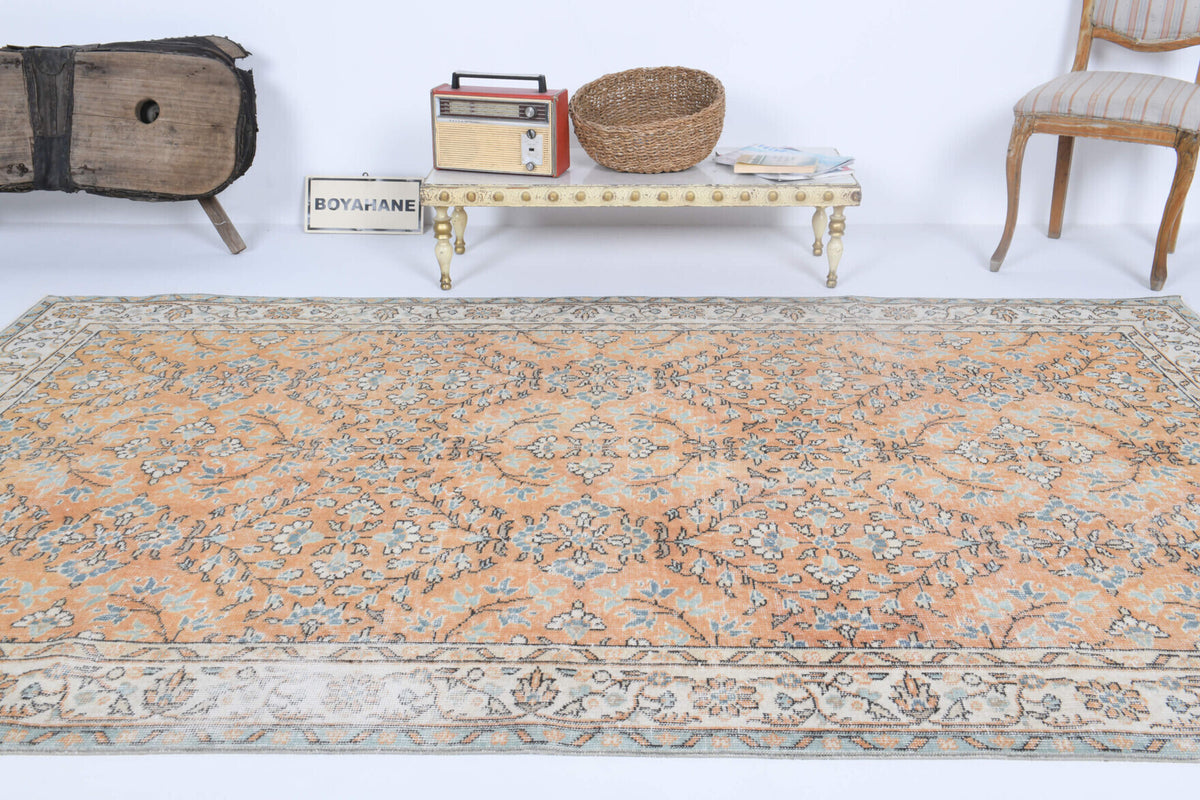 Nikomira rug: 1970s handmade Anatolian rug with bordered and floral motifs and cotton backing