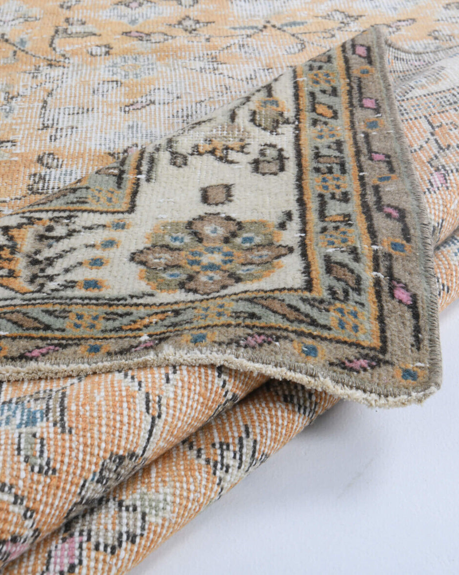 Nimet rug: 1960s handmade Anatolian rug with floral motifs and cotton backing