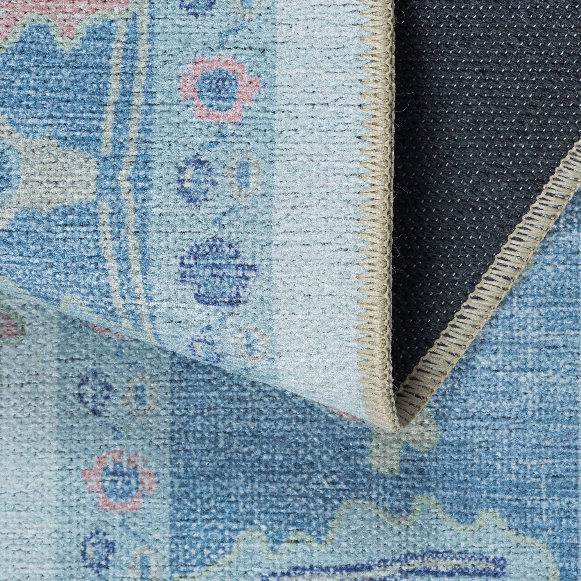 Close-up of a flatweave rug, showcasing its thin profile and clean, woven texture, for a modern minimalist style. 