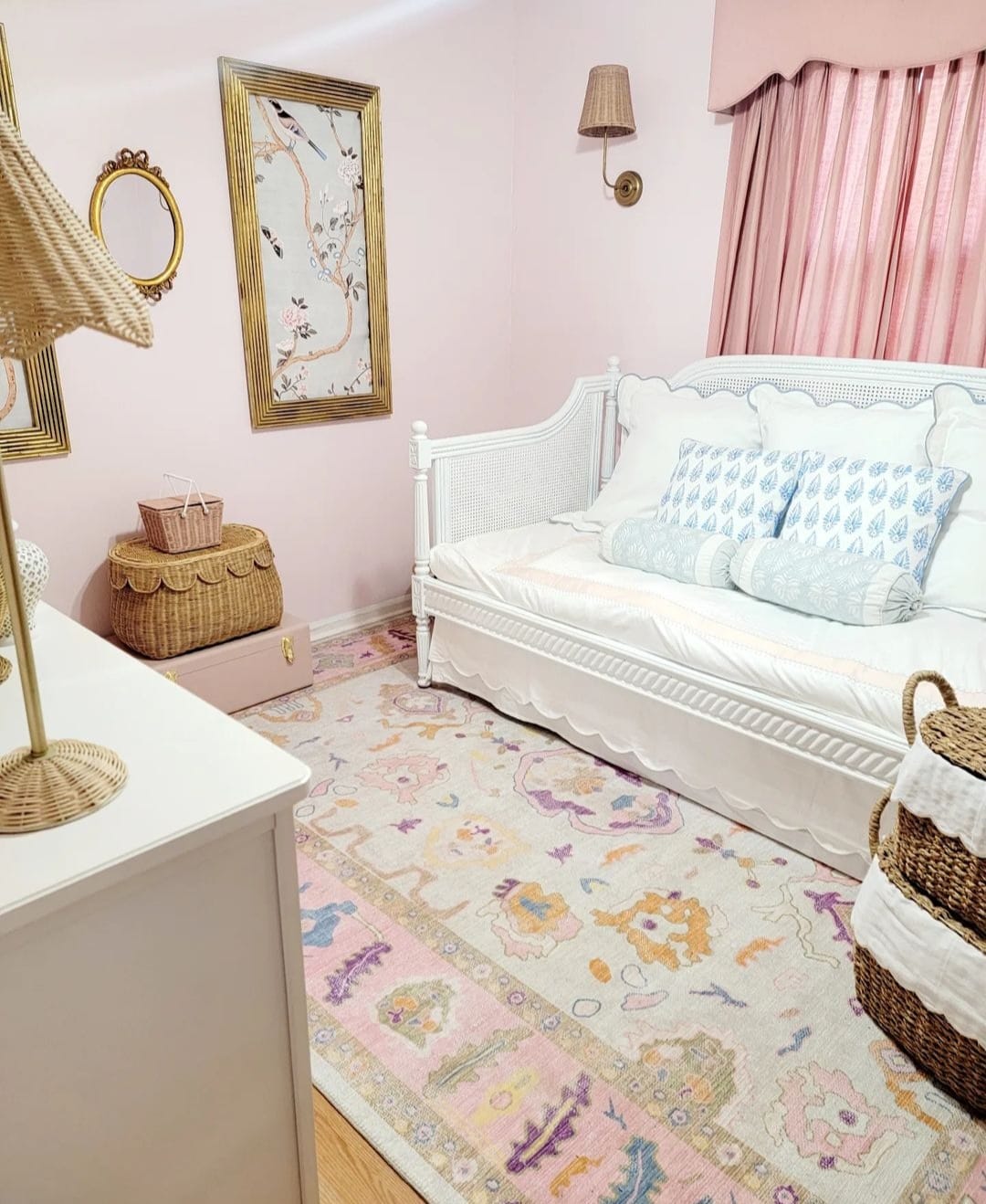 Pink Oushak rug styled in a daughter’s bedroom, complementing soft wall colors, furniture, and curtains for a cohesive look