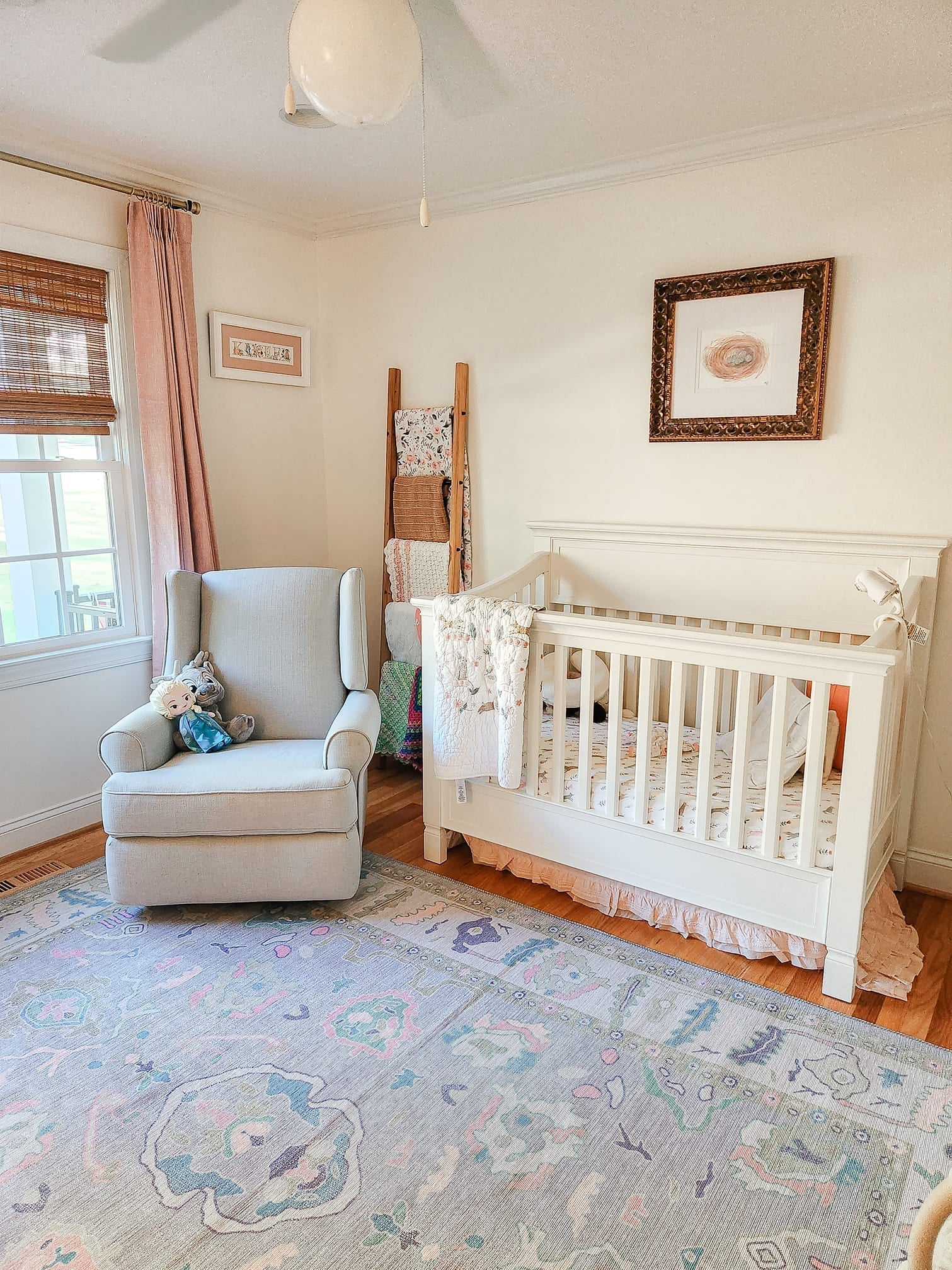 Cozy nursery with a soft lavender rug adding warmth and charm to the room, perfectly complementing the crib and pastel décor.