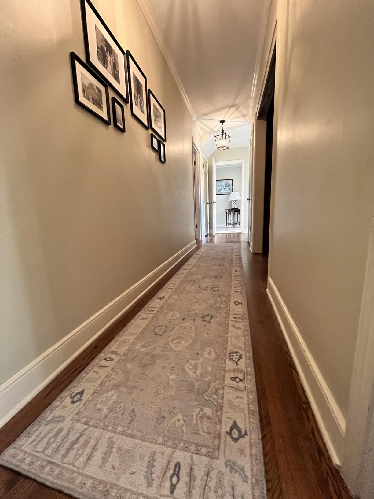 Washable gray Oushak runner rug enhancing a bright hallway with vintage-inspired charm