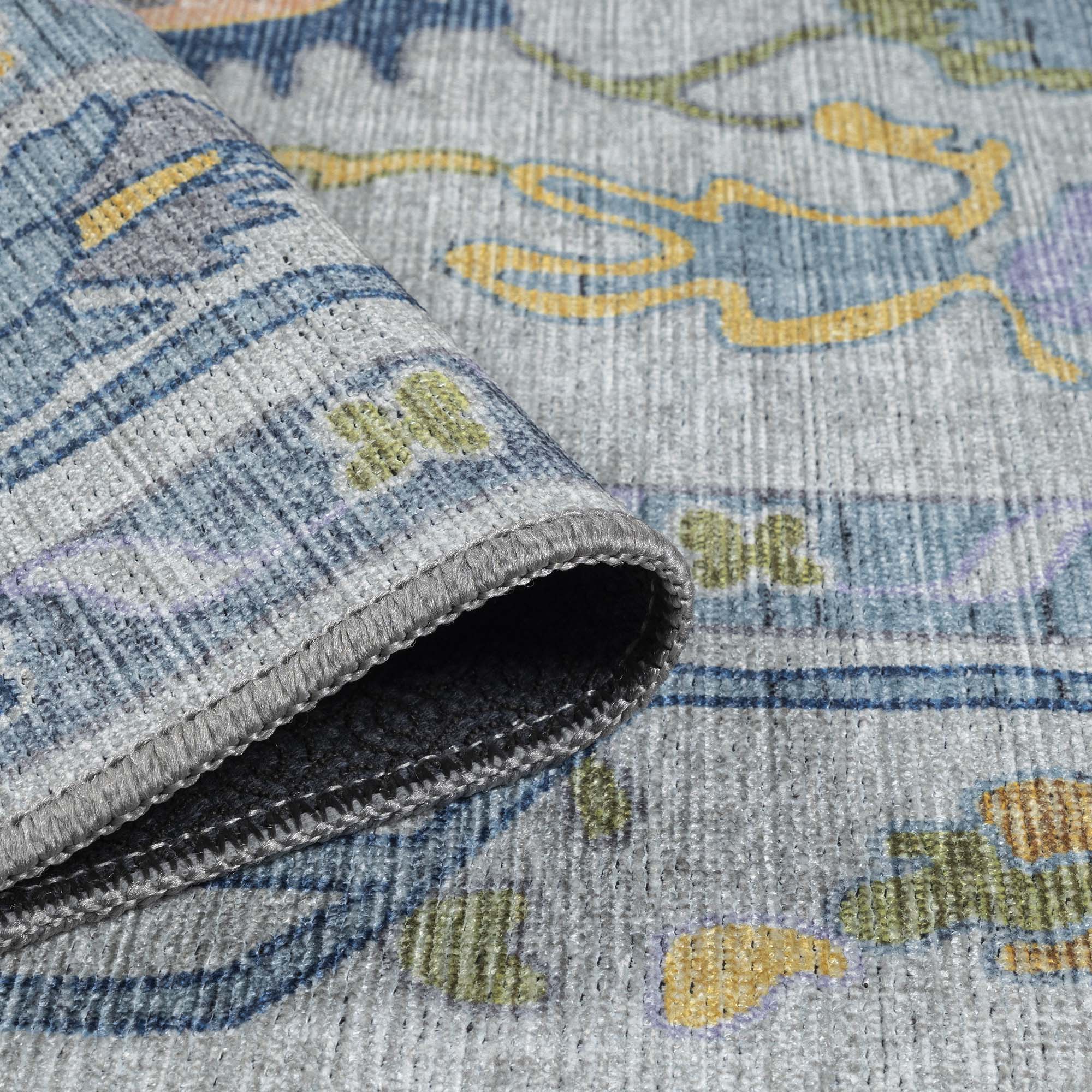 Close-up of a blue area rug highlighting calming color and woven texture. 