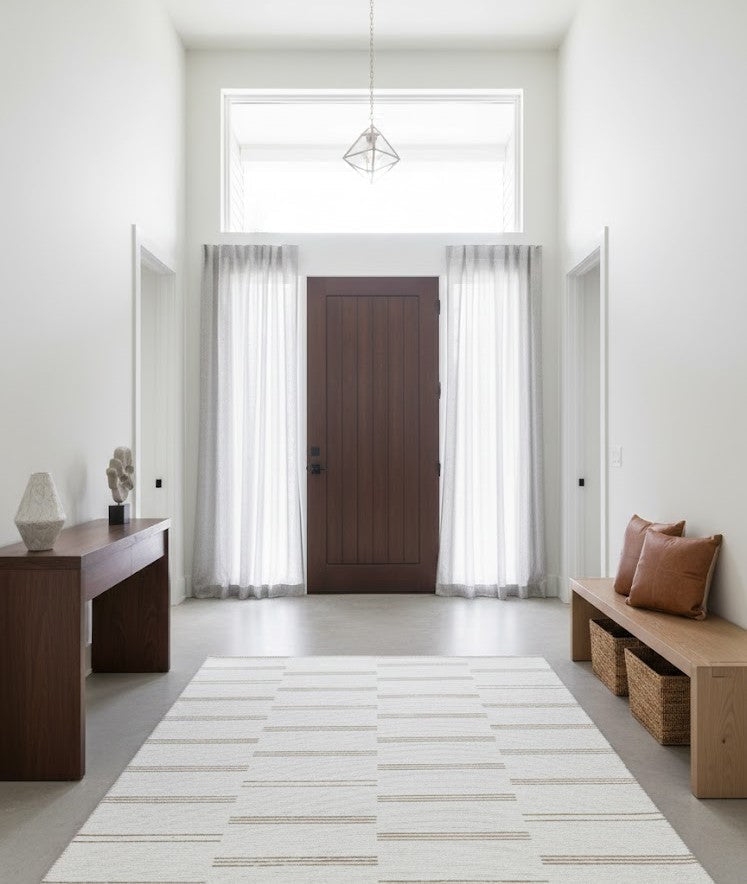 Neutral area rug in a modern home entryway with clean lines and minimal décor