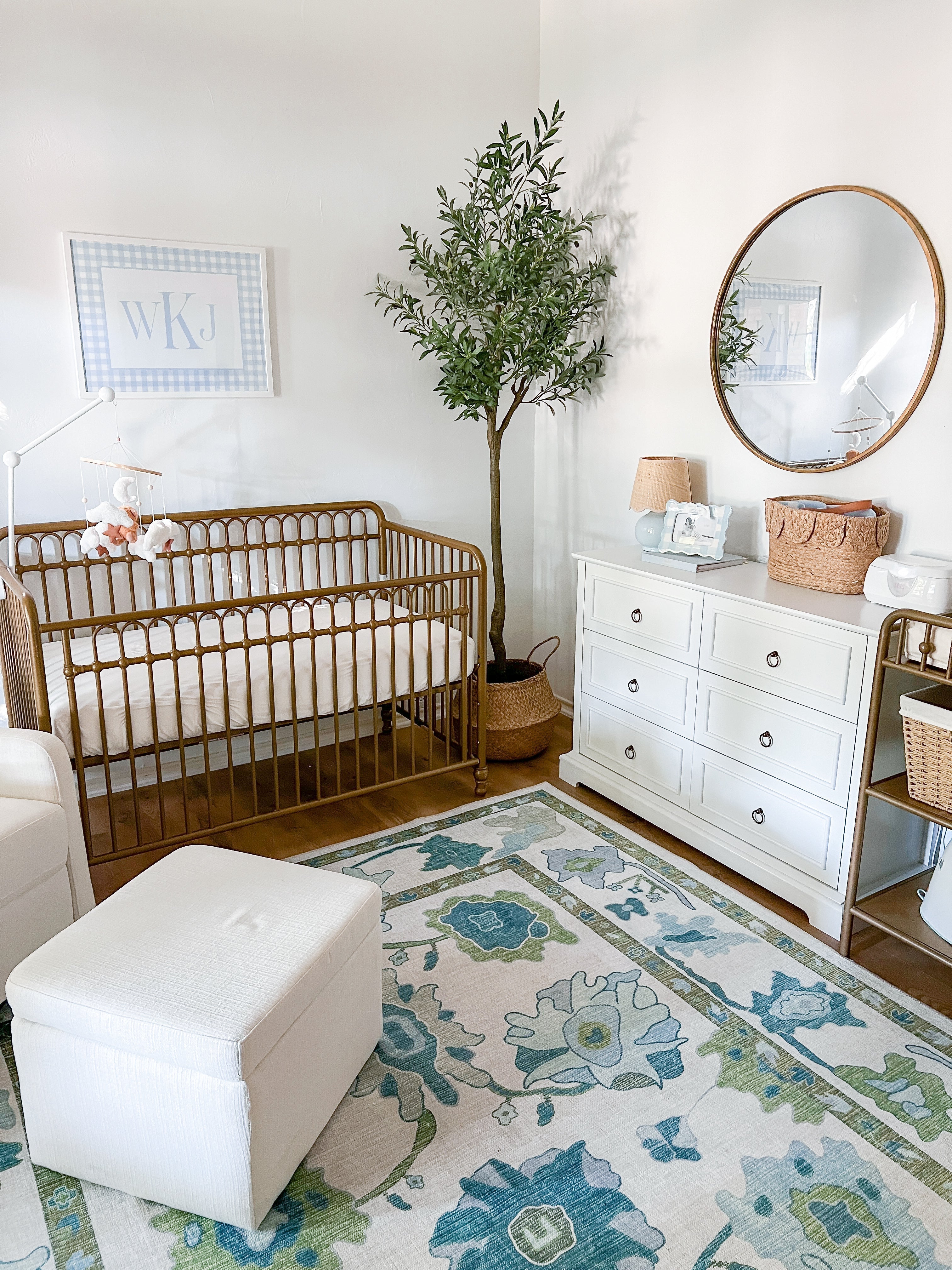 Floral green and blue Oushak-style rug creating a cozy and calming nursery space