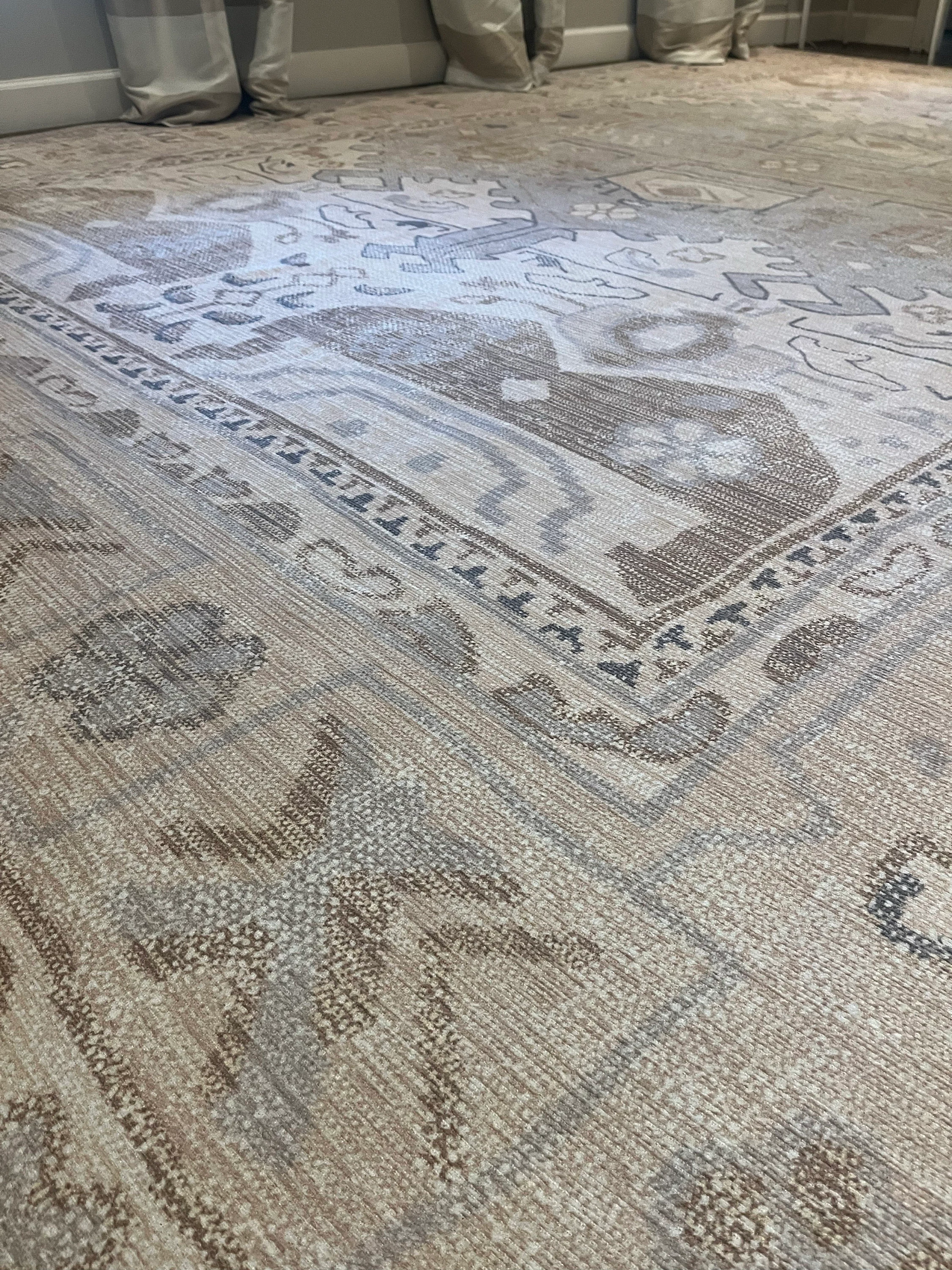 Neutral beige area rug in a modern interior creating a calm, bright, and airy spring space