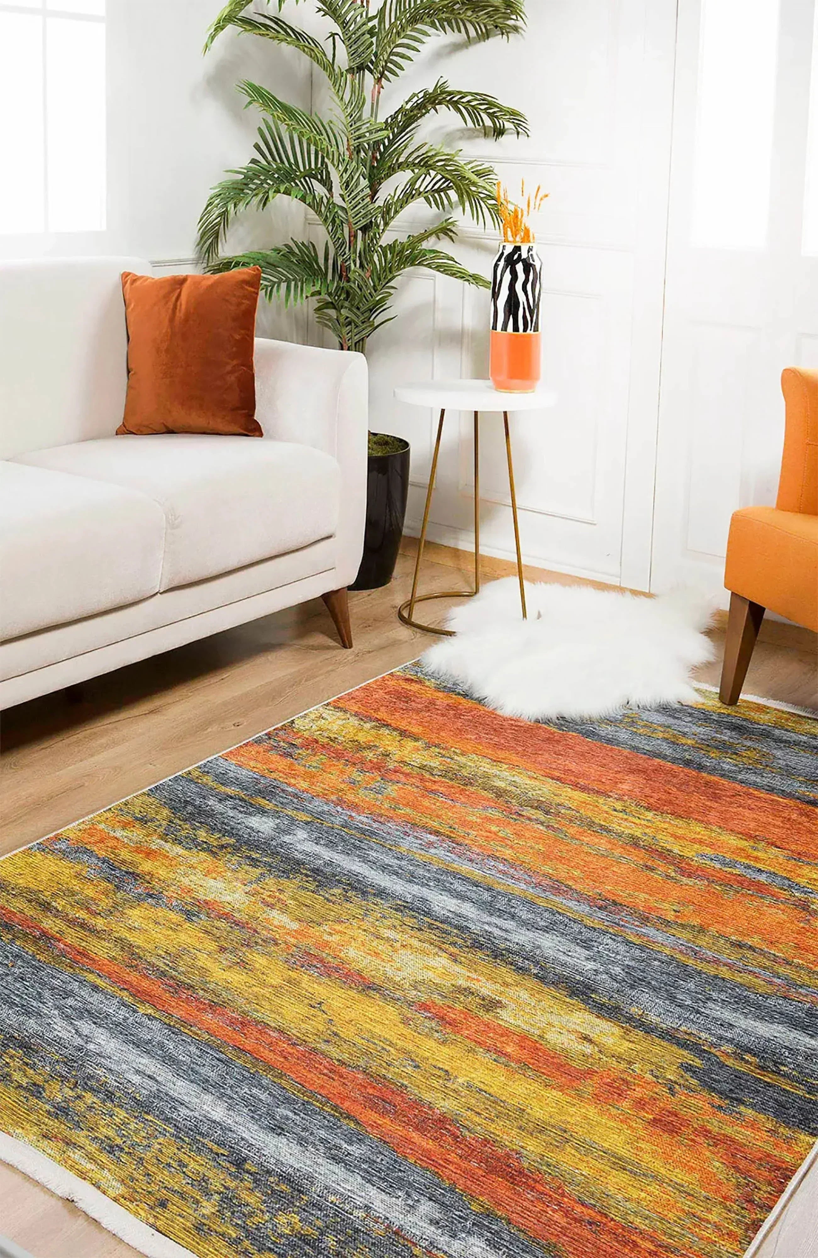 Ochre area rug adding warmth and color to a minimalist living room with beige furniture.
