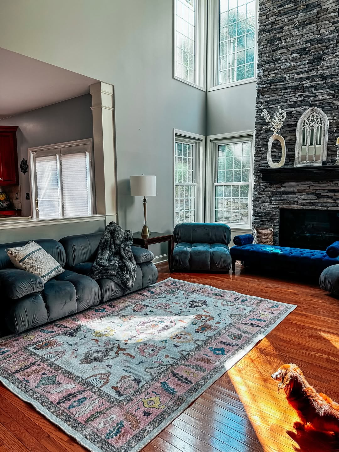 Modern living room with a medium-sized pink rug placed under a sofa, creating a cozy and stylish interior.