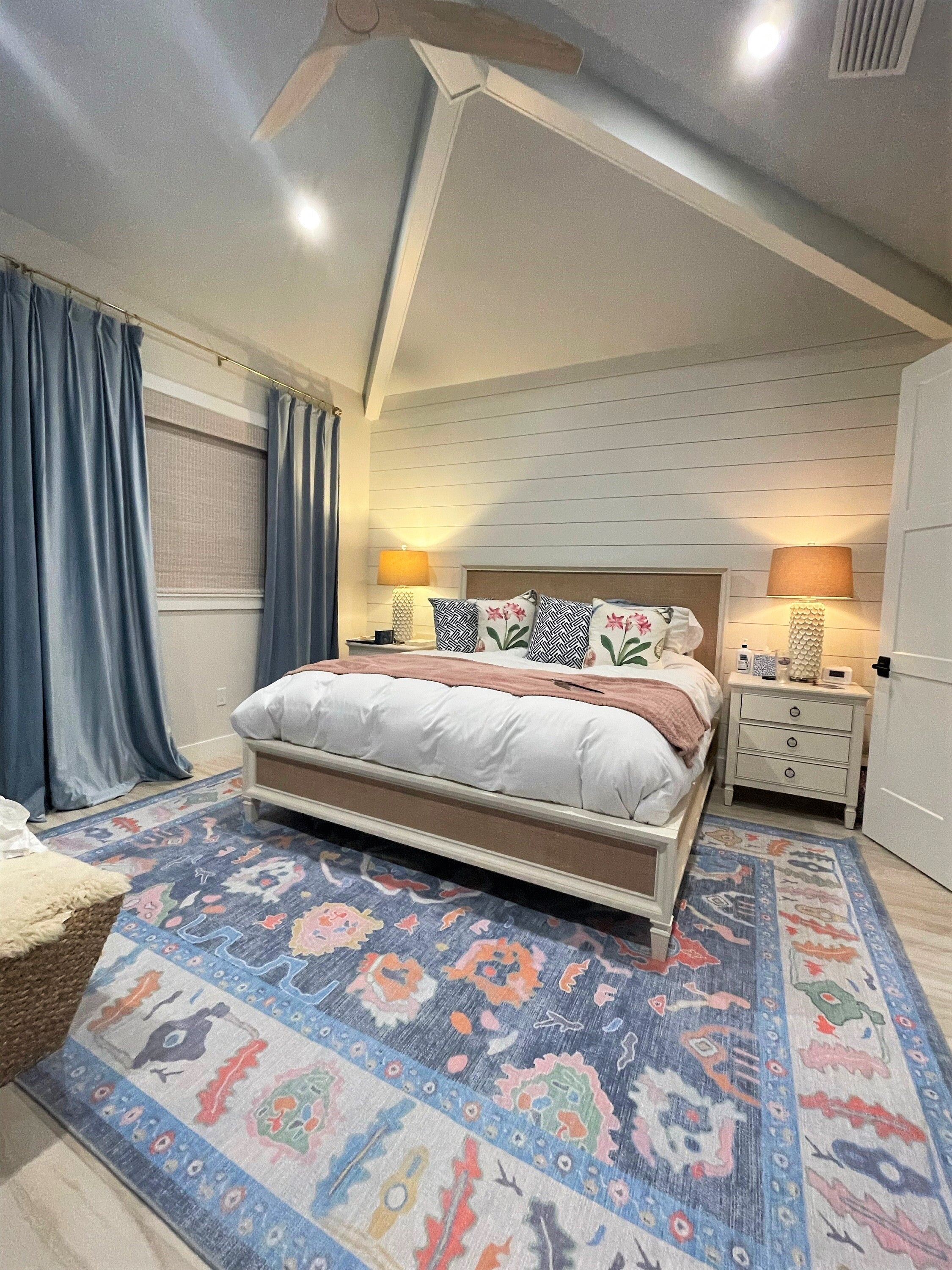 Large bedroom with a soft area rug helping reduce noise and improve home acoustics