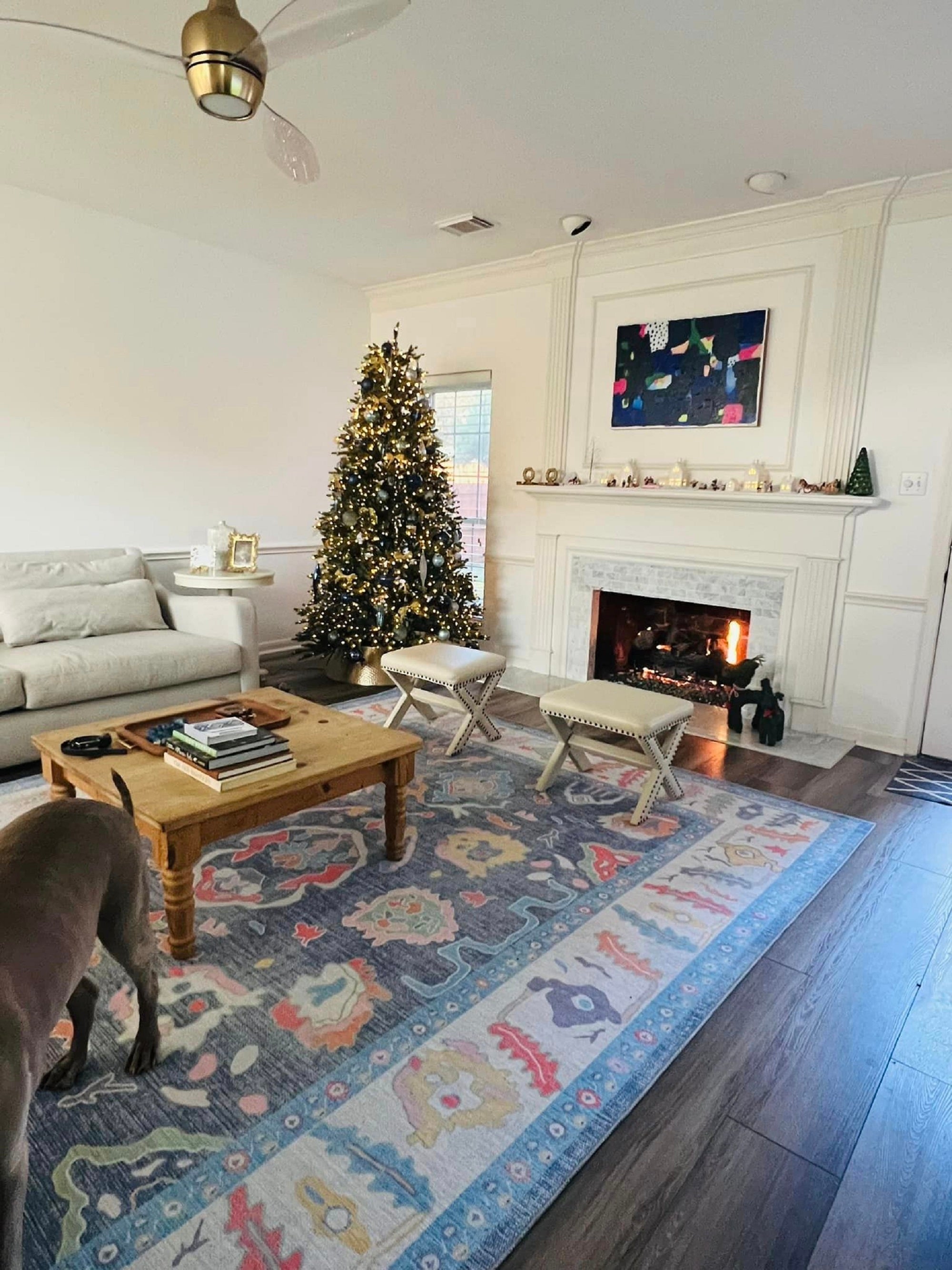 Festive living room with cozy Christmas décor and a winter-inspired rug.