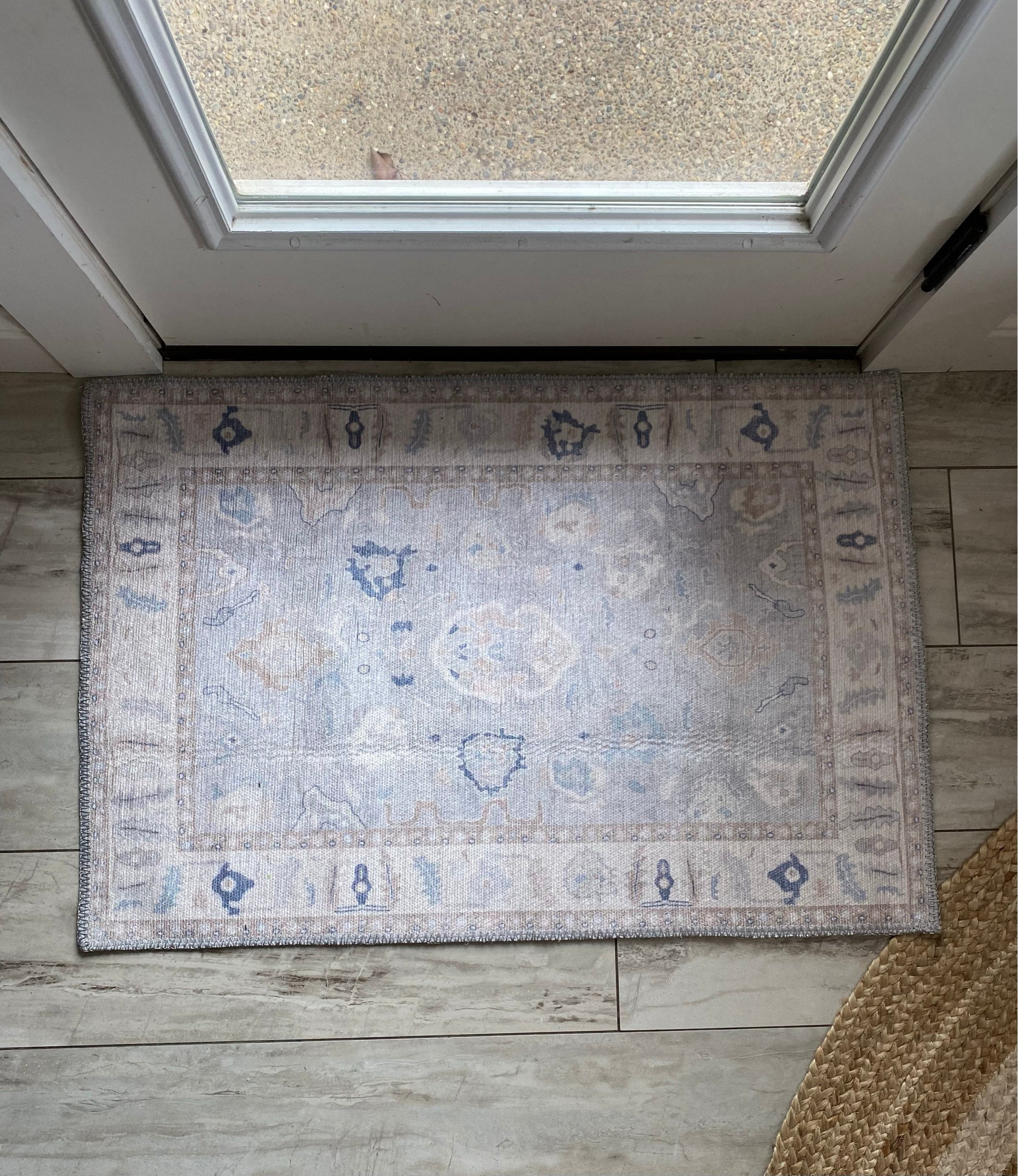 Welcoming entryway with a 2x3 rug placed near the door, adding warmth, style, and a functional touch to the small space.