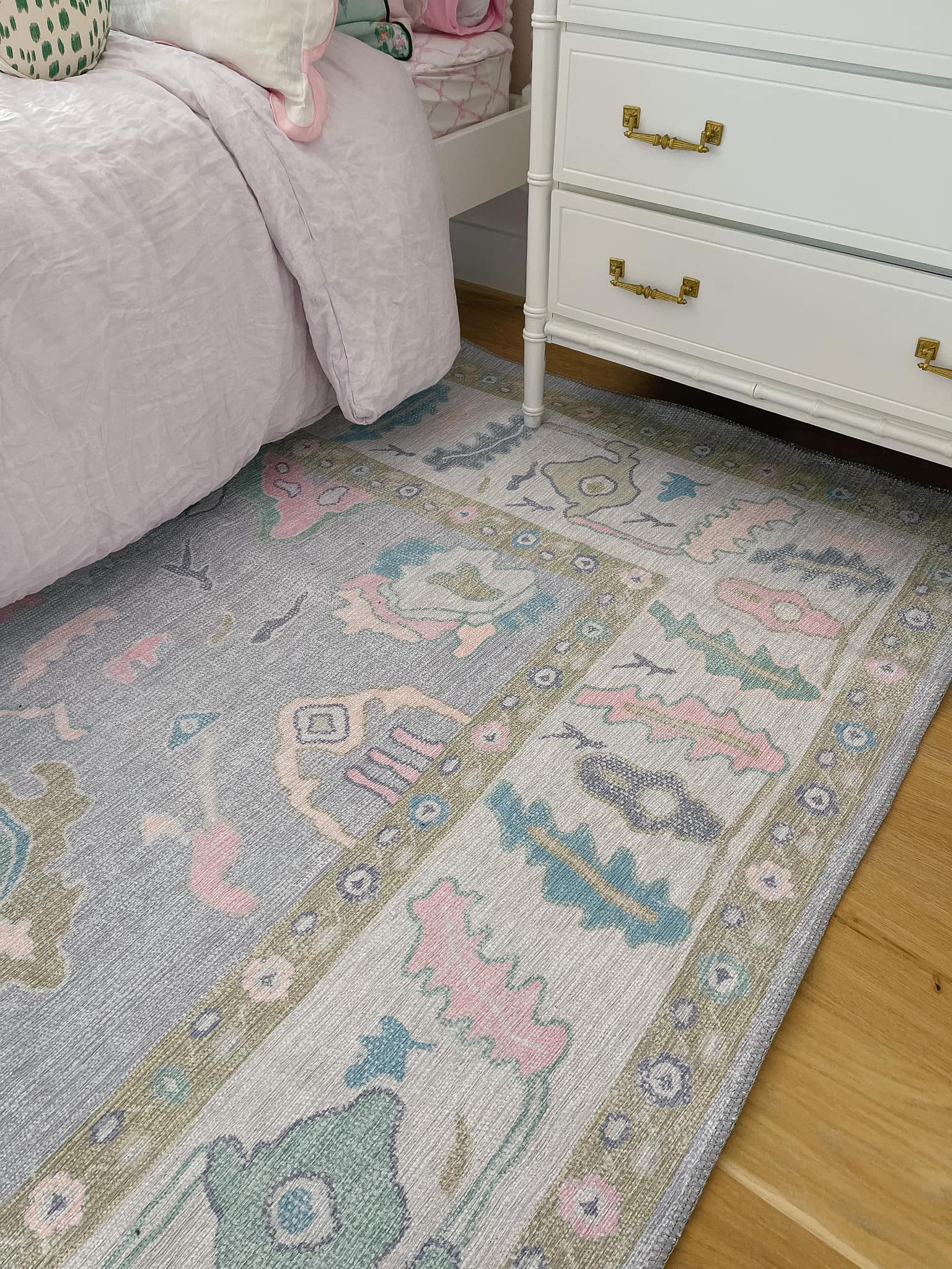 Stylish dorm room rug with a soft, low-pile texture in neutral tones, placed under a bed and desk to add warmth and define the space.