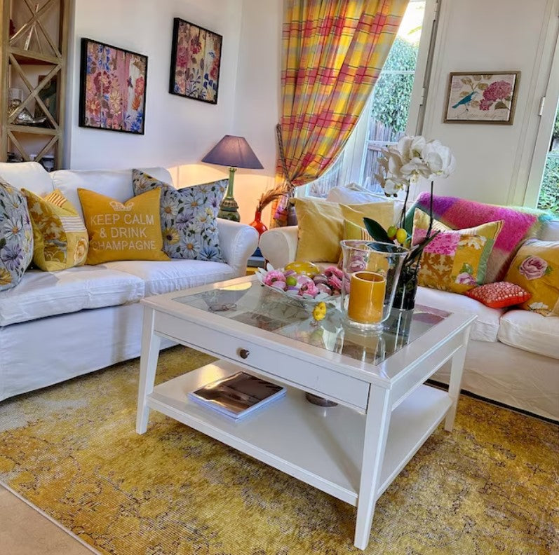 Yellow area rug anchoring a well-designed room and bringing warmth, balance, and visual focus