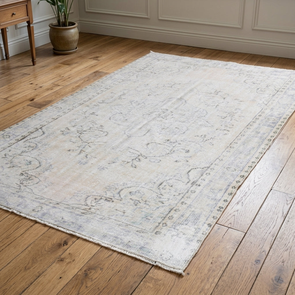 Sabahayat antique Turkish farmhouse rug in a living room with sofa – 1970s ivory wool rug, 5'4" x 8'4" (163x254 cm)