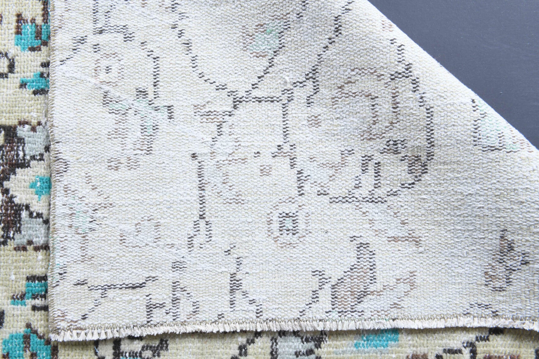 Cemileperver rug: 1970s handmade Anatolian rug with floral motifs and cotton backing