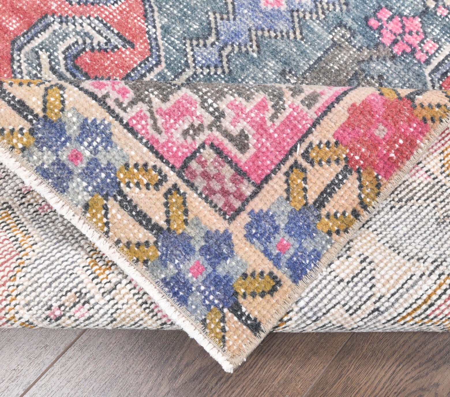 Naiasthene rug: 1970s handmade Anatolian rug with floral motifs and cotton backing