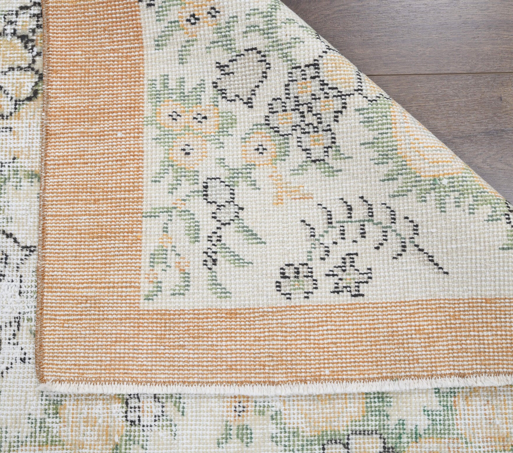 Rhodozoe rug: 1960s handmade Anatolian rug with floral motifs and cotton backing