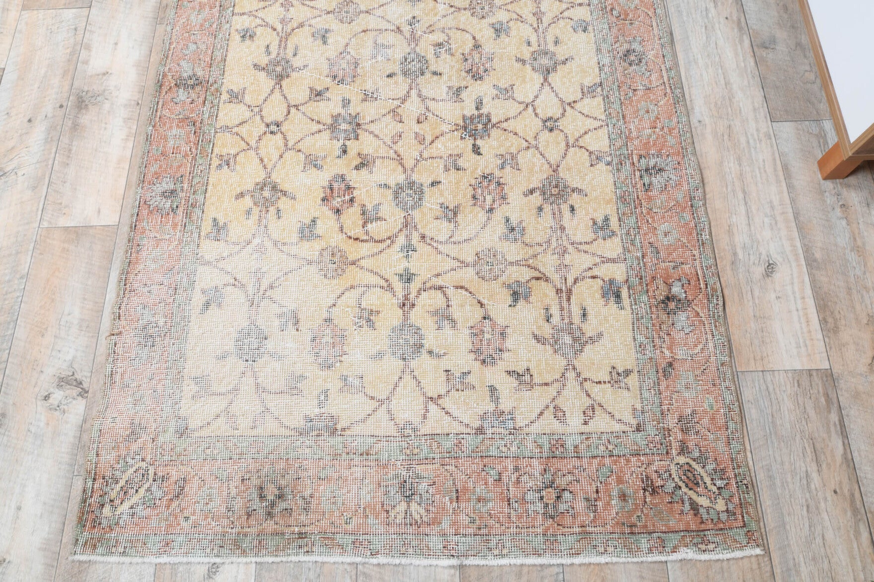 Filiznur rug: 1970s handmade Anatolian rug with bordered and floral motifs and cotton backing