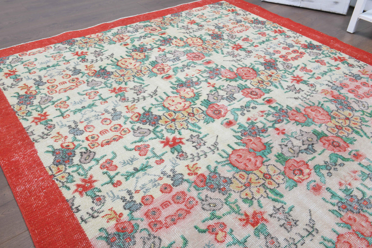 Authentic Anatolian antique washed vintage area rug (1970s) with bordered and floral design – one-of-a-kind at Fame Rugs