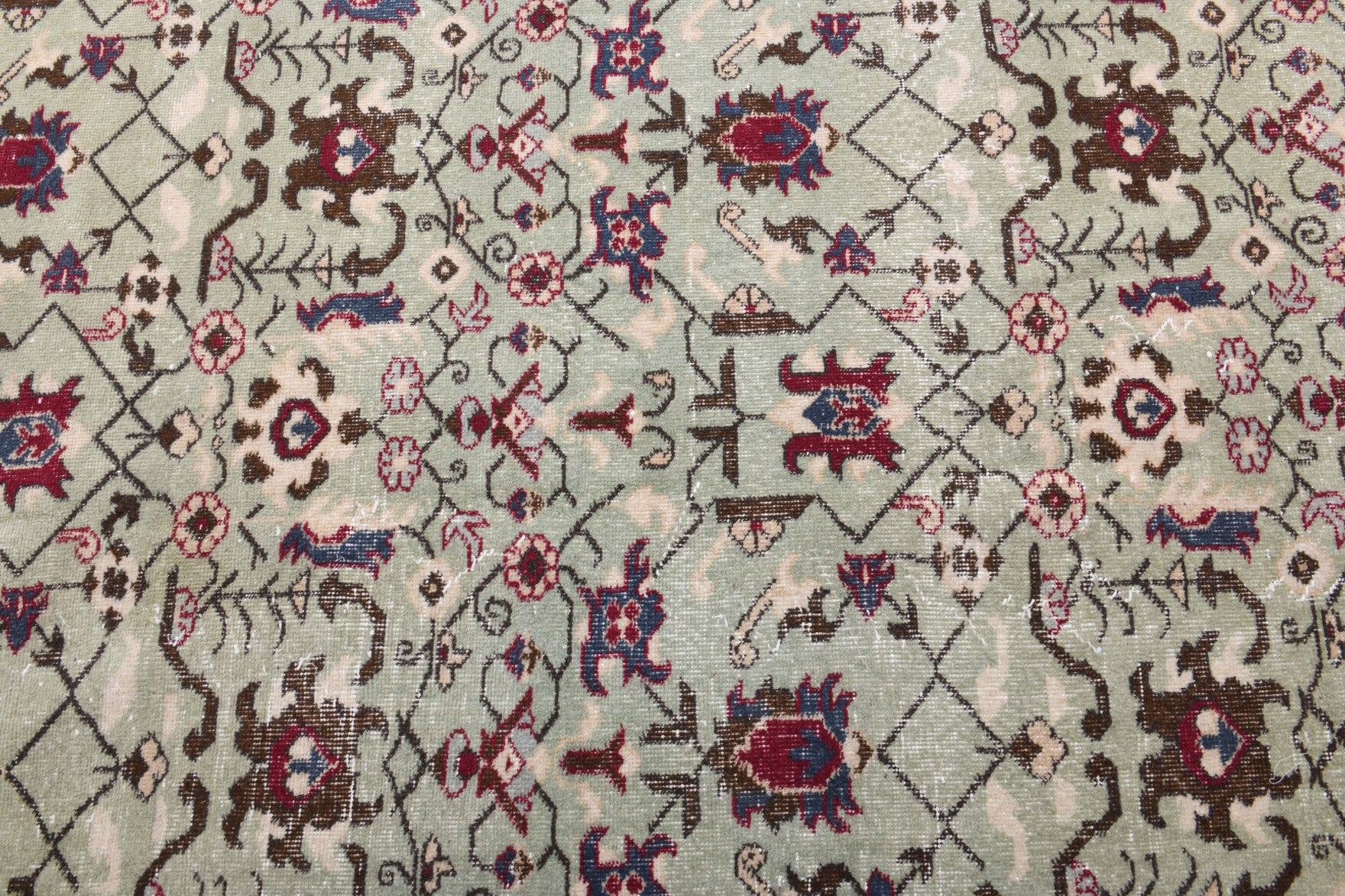 Zulalmelek rug: 1970s handmade Turkish rug with floral and bordered motifs and cotton backing