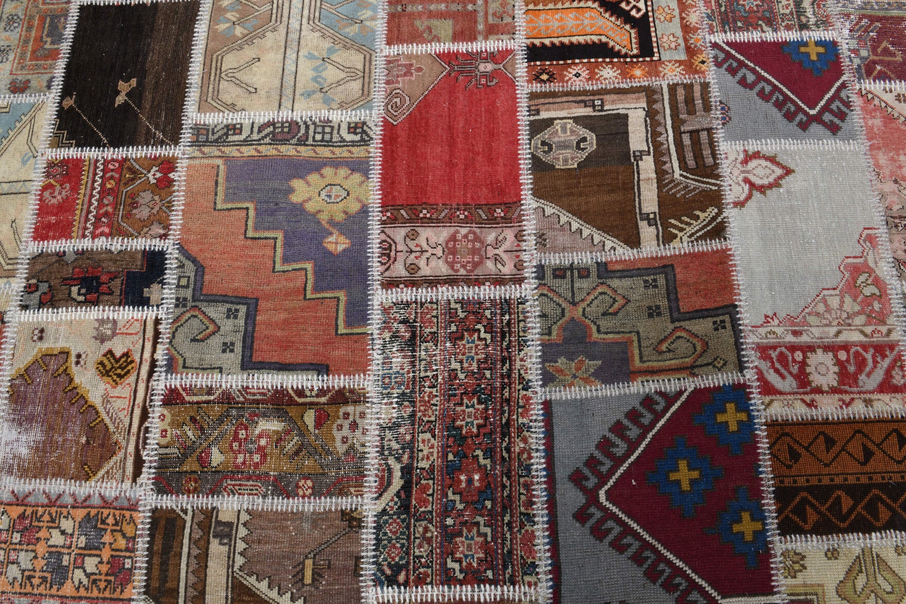 Ahubahar rug: 1970s handmade Anatolian rug with tribal motifs and fabric backing