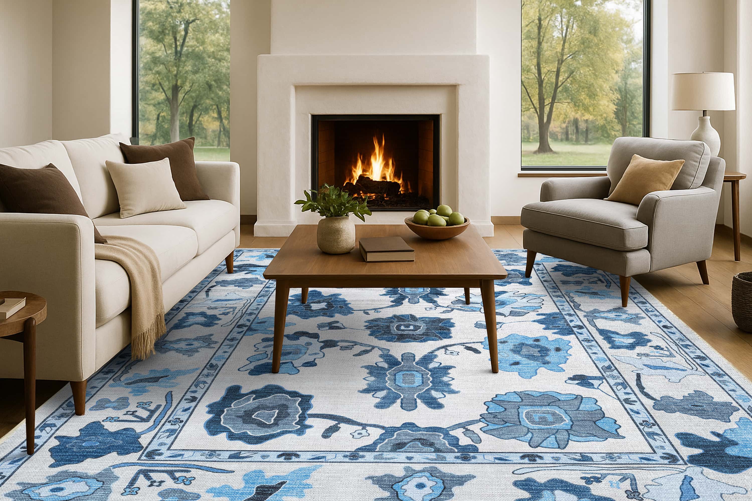 Living room with a blue and white patterned rug, fireplace, and furniture. Ellis Navy Blue White Modern Floral Oushak Rug