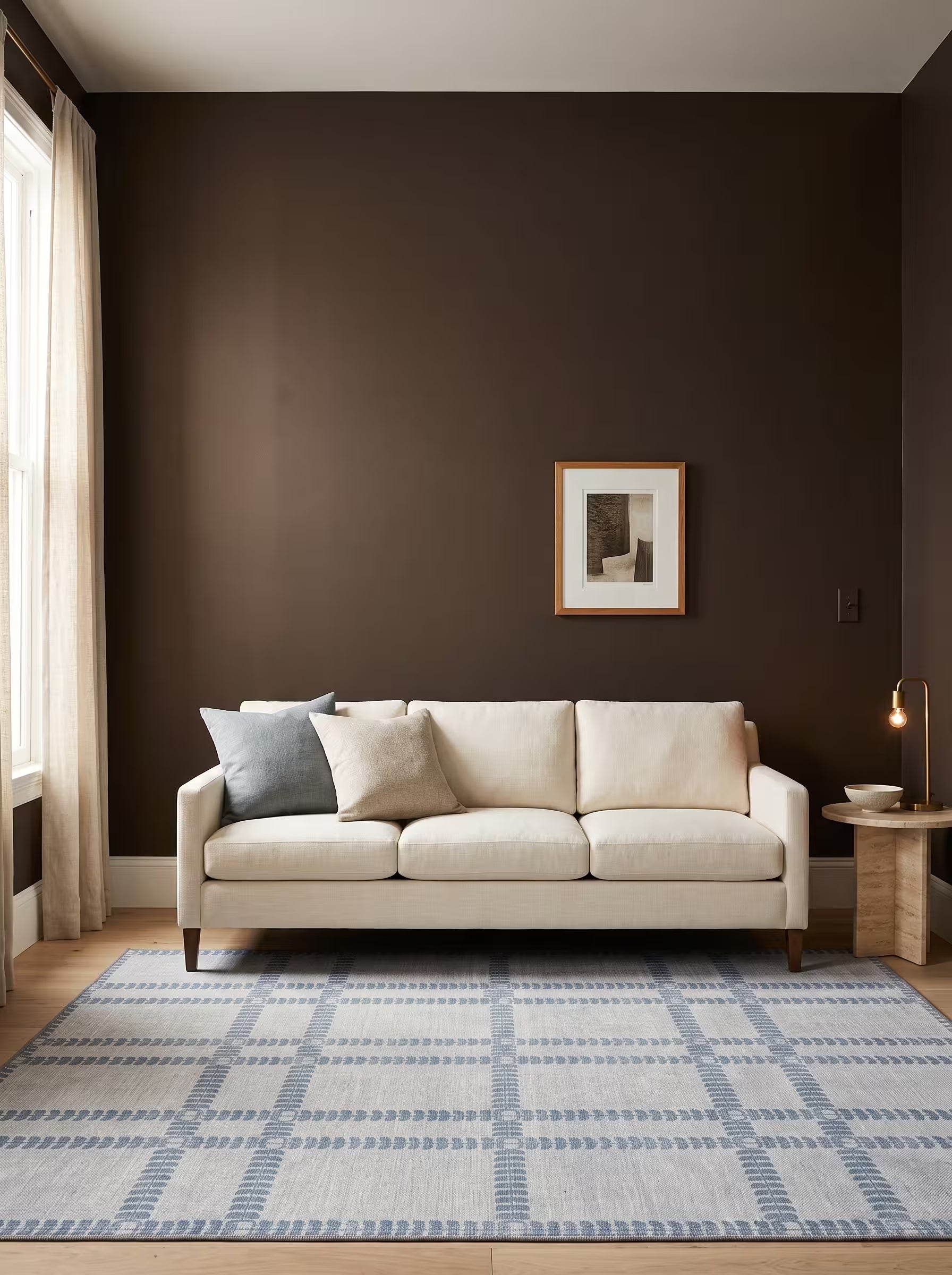 Cream and blue-grey area rug in a living room with deep warm brown painted walls