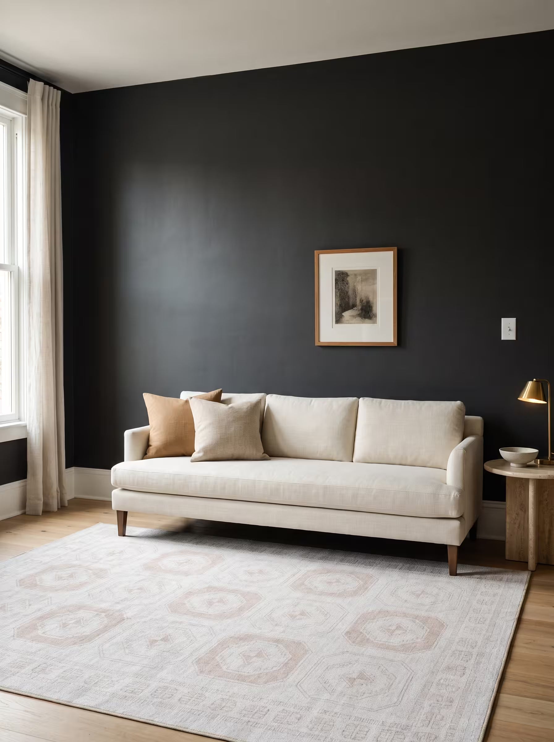 Ivory and camel area rug in a living room with charcoal painted walls