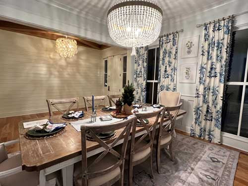 Dining room with a wooden table, chairs, and decorative elements. Dining Room Rugs - Fame Rugs