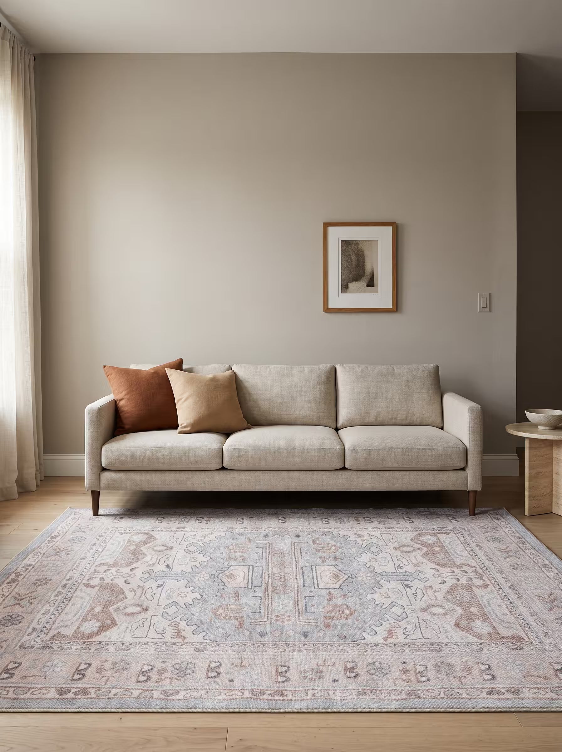 Cream and rust area rug in a living room with warm greige painted walls