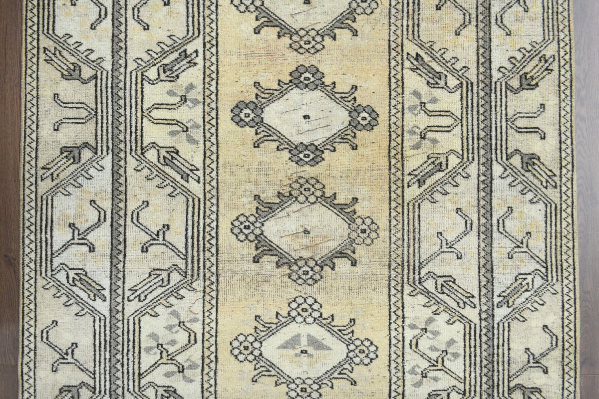 Zeynepmelek rug: 1970s handmade Anatolian rug with tribal motifs and cotton backing