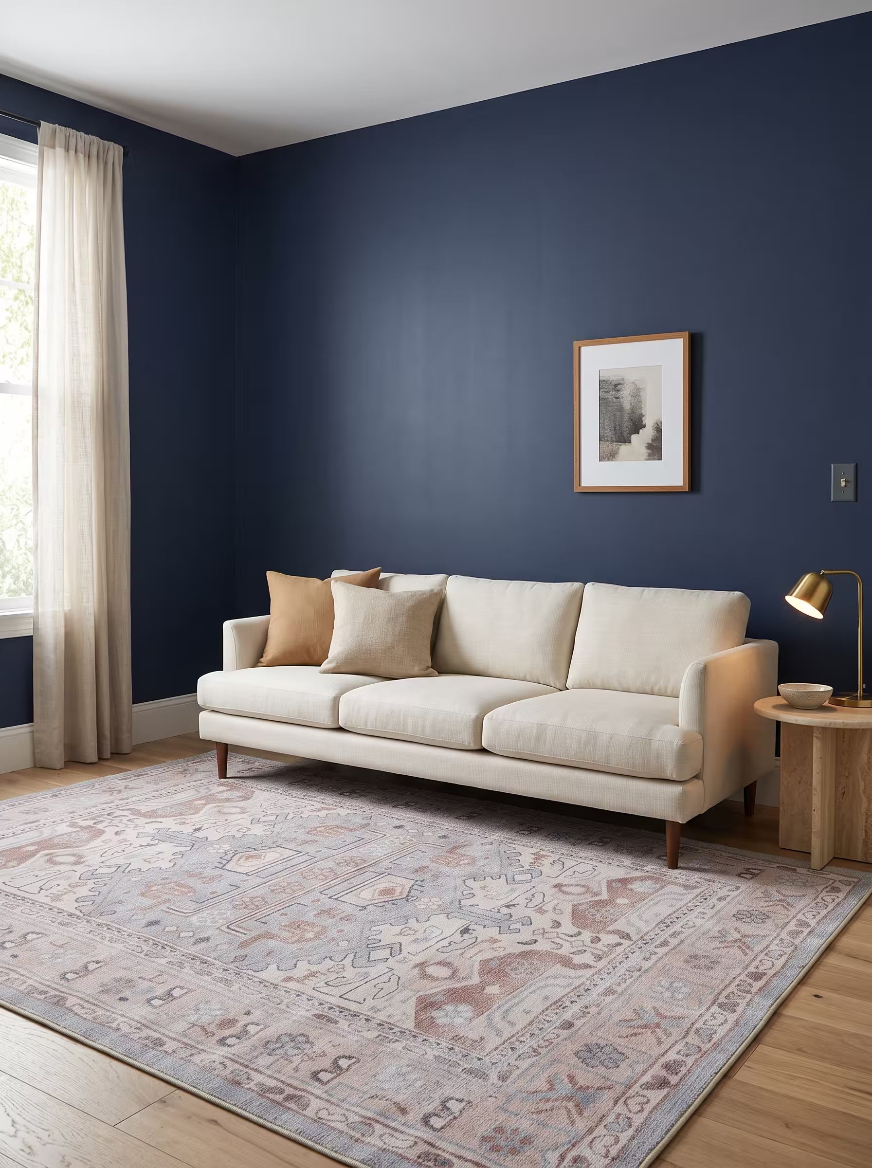Ivory and camel area rug in a living room with deep navy painted walls