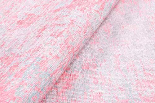 Close-up of pink and gray textured fabric. Pink Rugs - Fame Rugs