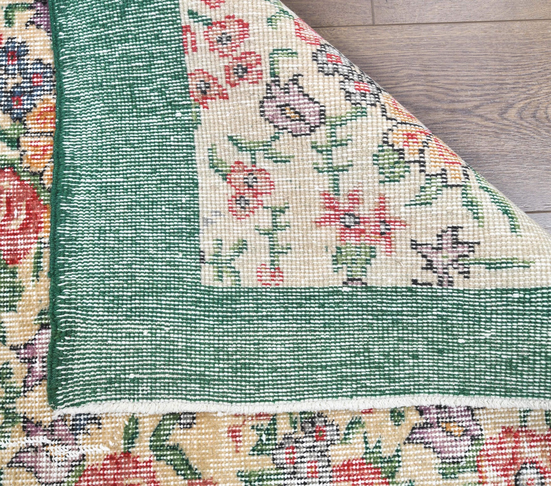 Argyrozoe rug: 1970s handmade Anatolian rug with floral motifs and cotton backing