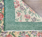 Argyrozoe rug: 1970s handmade Anatolian rug with floral motifs and cotton backing