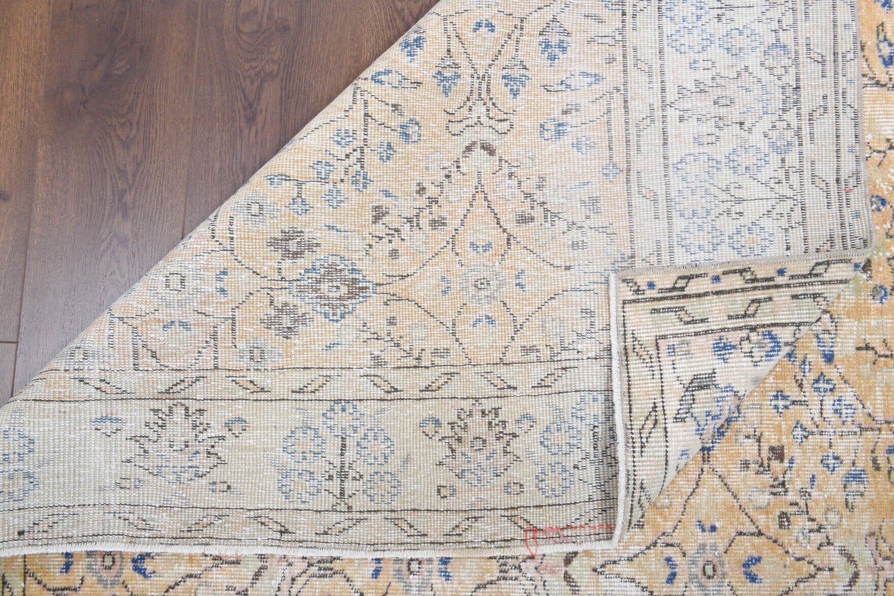 Sedanurmelek rug: 1970s handmade Anatolian rug with floral motifs and cotton backing
